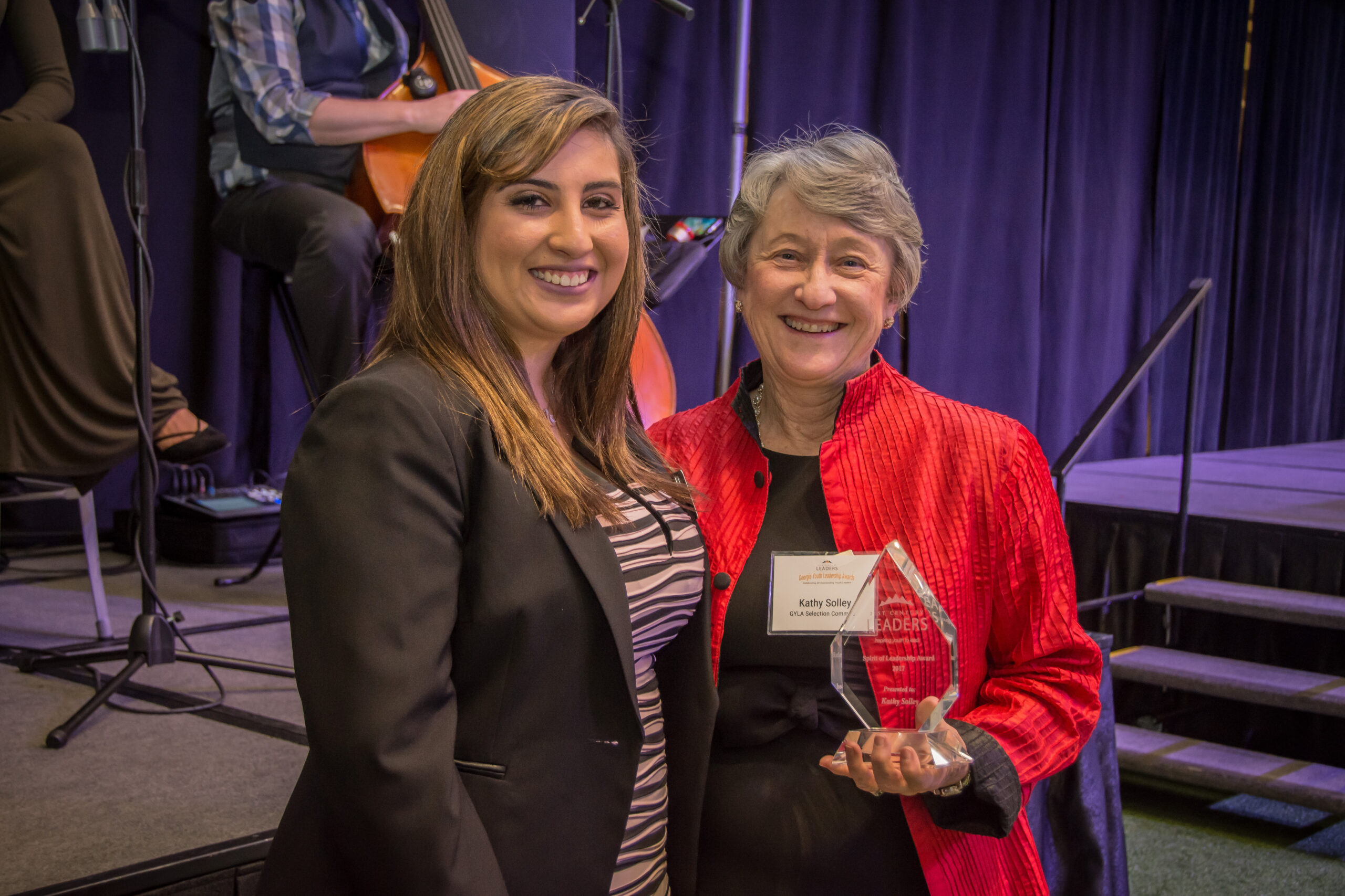 21CL Board of Directors, Maria Flores-Blackburn presents the first "Spirit of Leadership Award" to Kathy Solley.